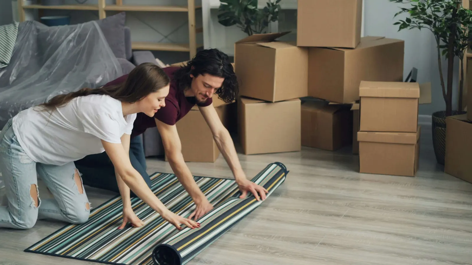 Rolling a carpet in a house 